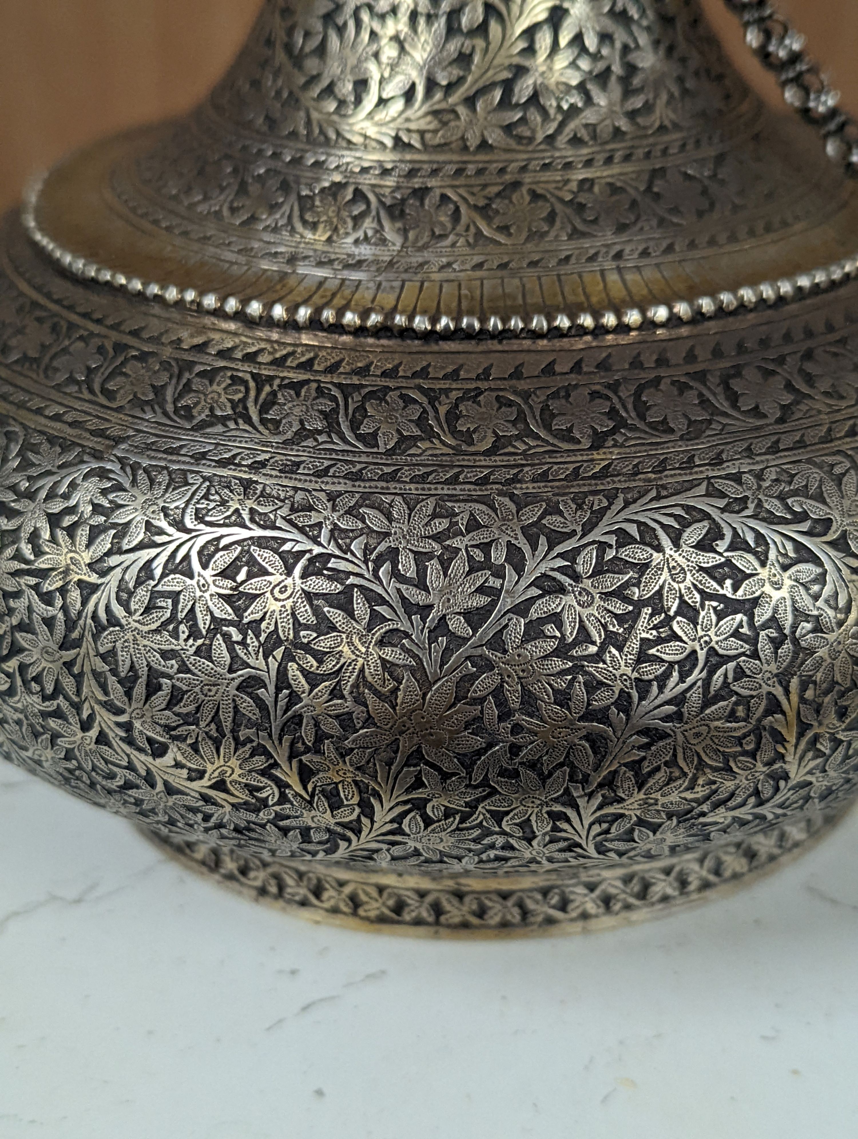 A 19th century North Indian silver surahi with engraved shawl decoration 30cm